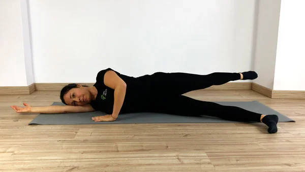 Posición de patada detrás en patada delante y detrás. Fátima Pastor ejecutando el ejercicio de Pilates Mat